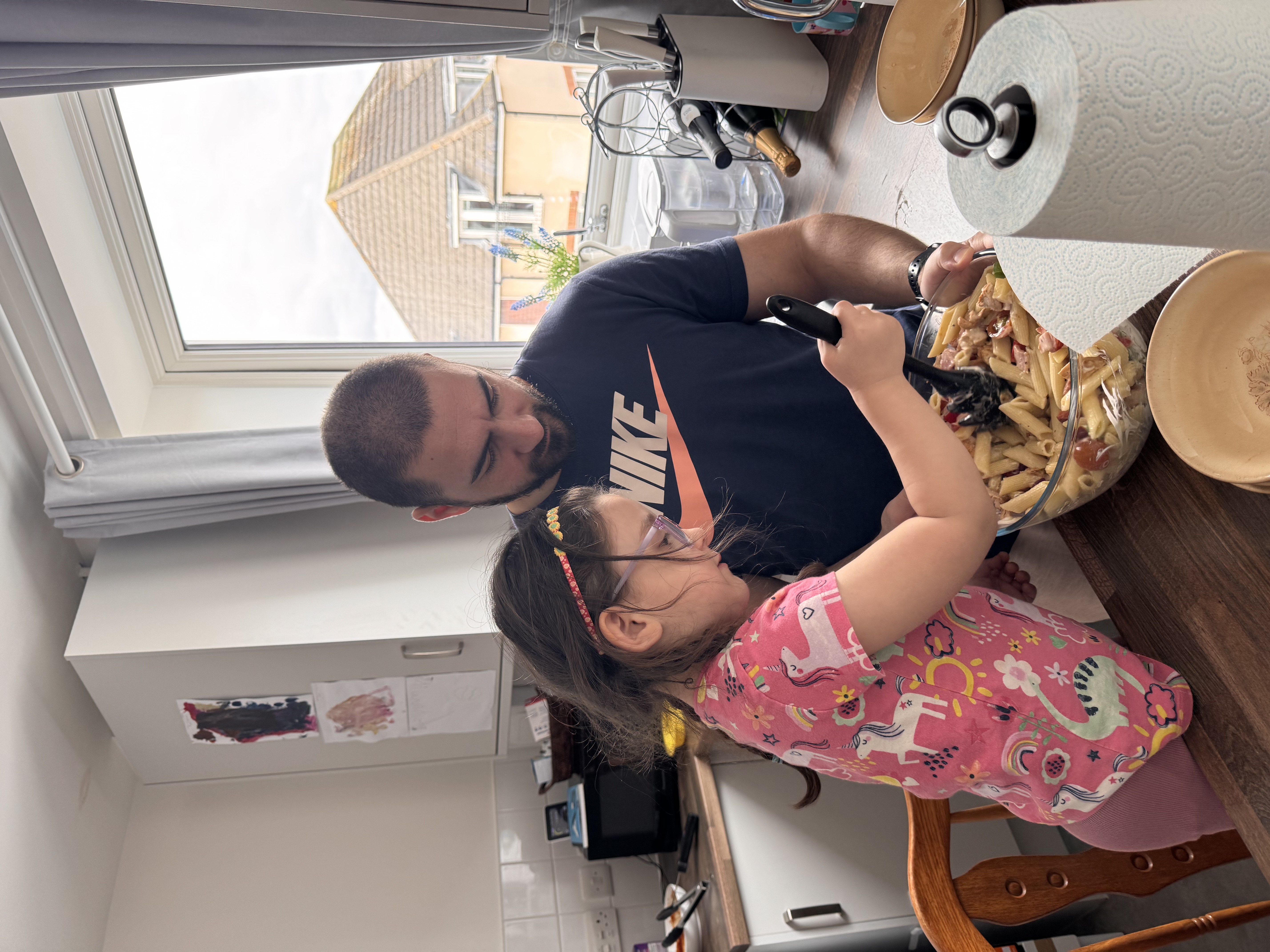 Dad and daughter cooking pasta